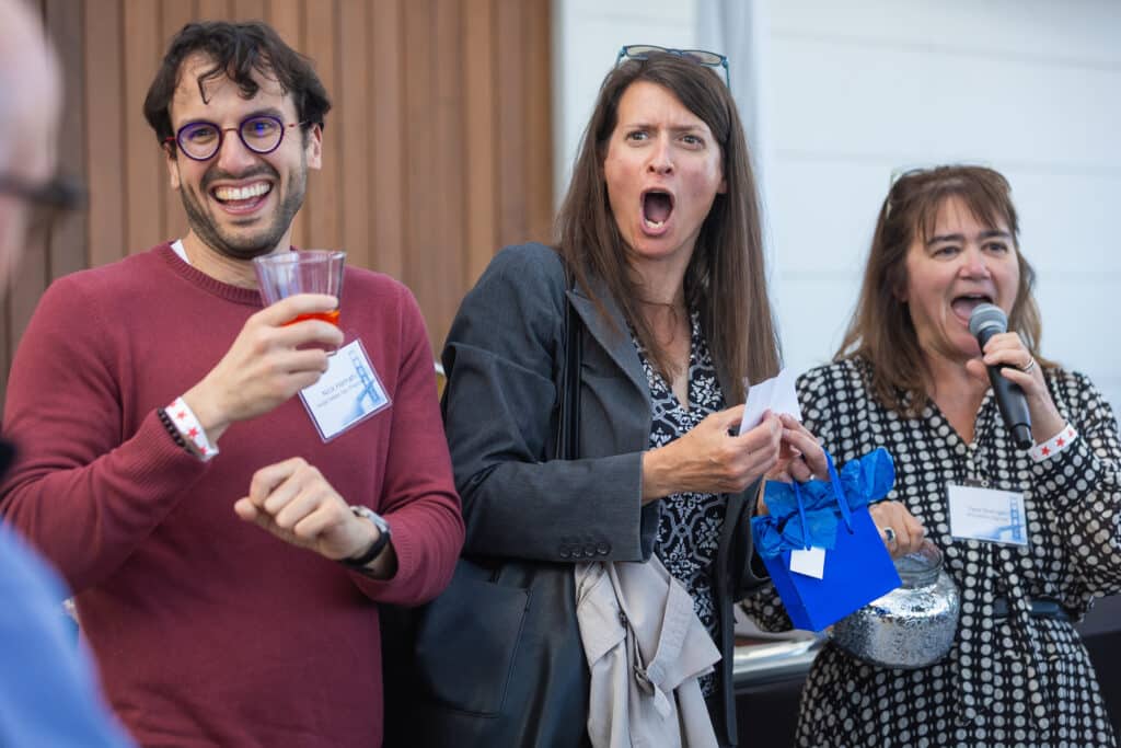Priceline conference attendees interacting and laughing during the General Conference in San Francisco.