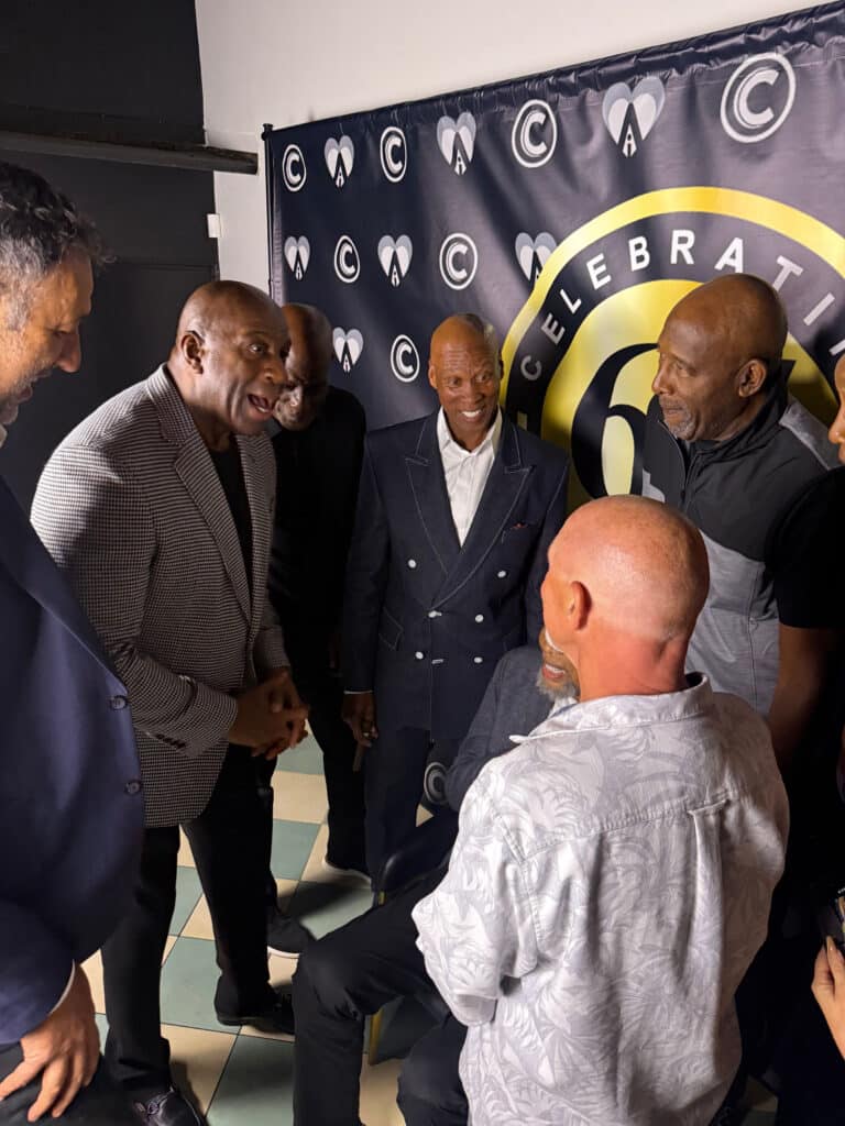Byron Scott and guests at birthday celebration, red carpet backdrop and photography.