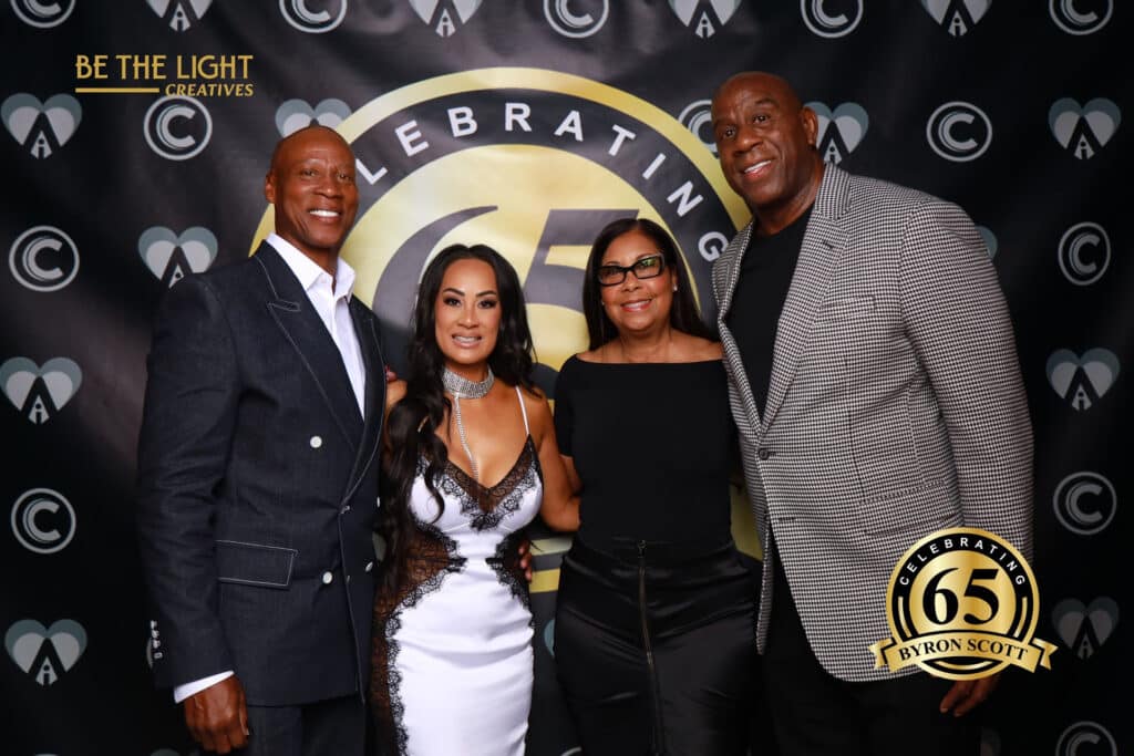 Byron Scott and family on red carpet at 65th birthday celebration, Be The Light Creatives backdrop.