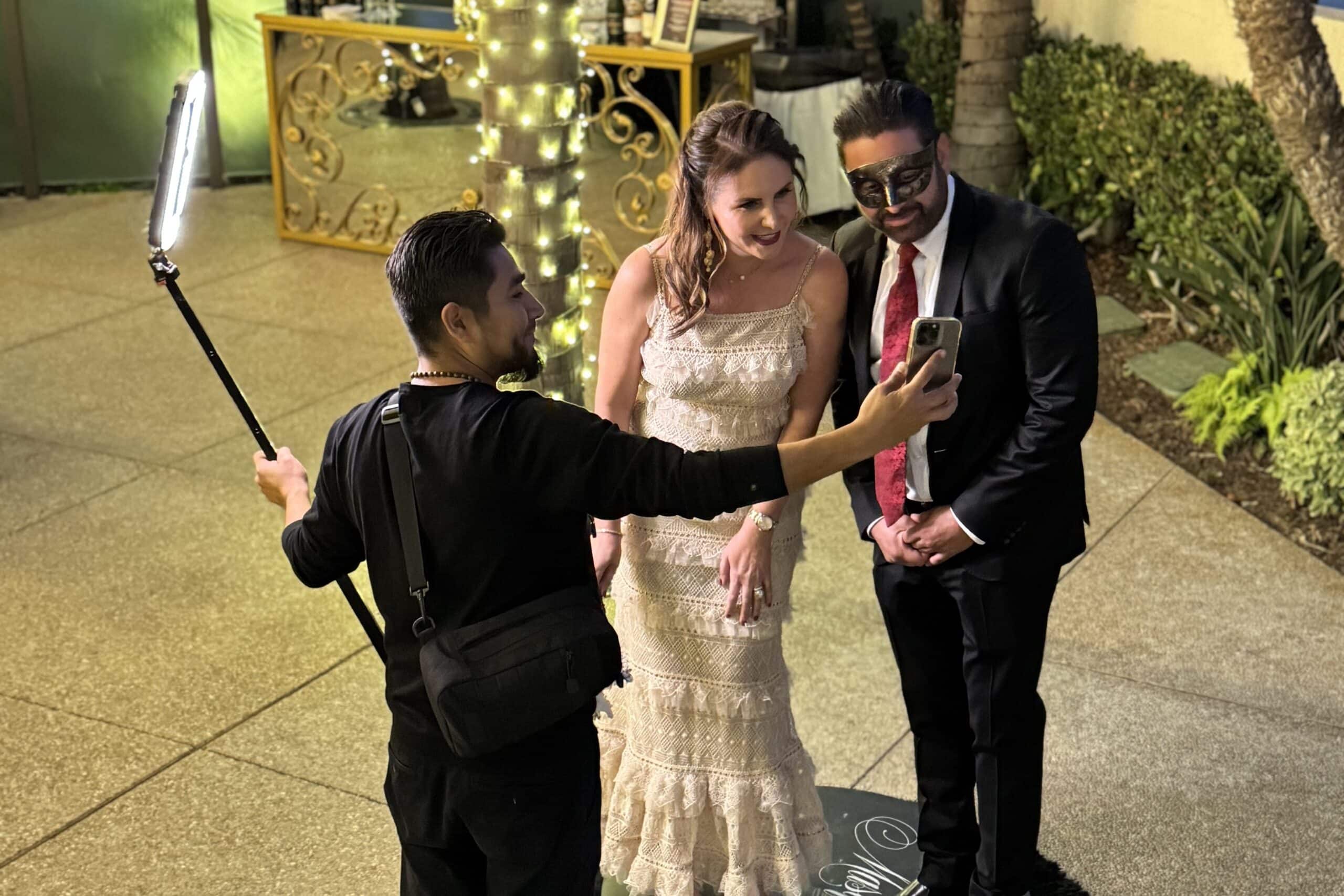 Luxury photo booth experience in Los Angeles, guests and photographer with professional lighting and smartphone