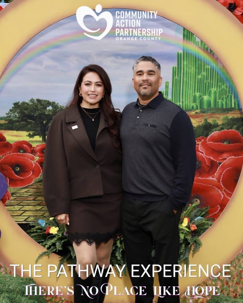 couple posing in front of a colorful corporate custom backdrop